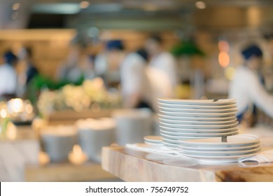 Stack Of Plate On Counter And Blurred Background. Groups Of Chef Preparation Counter Of Food In The Open Kitchen, International Buffet Dinner Food.