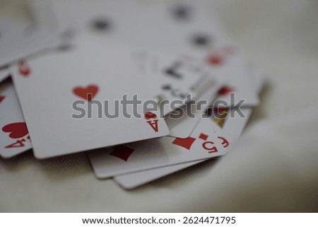 Stack of playing cards with a focus on the Ace of Hearts, captured in high detail, perfect for gaming, entertainment, and strategy-themed visuals
