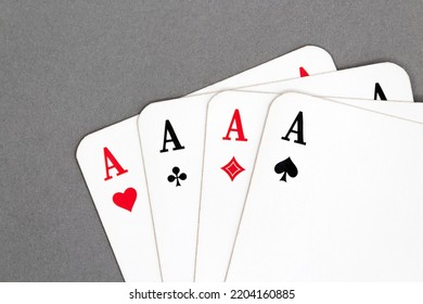 Stack of playing cards four aces isolated on a gray background 