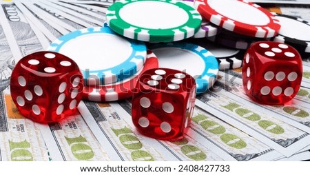 Stack of Poker chips with dice rolls on a dollar bills, Money. Poker table at the casino. Poker game concept. Playing a game with dice. Casino dice rolls.