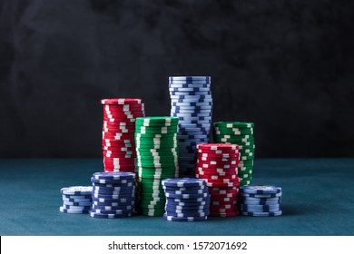 Stack Of Poker Chips On A Blue Table On A Black Background