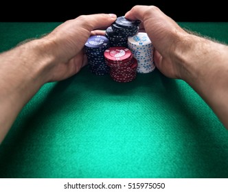 Stack Of Poker Chips And Two Hands On Green Table.