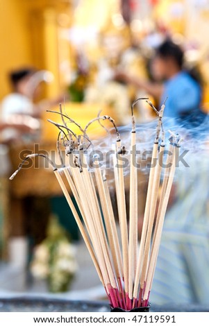 Stack of praying joss stick burns in the compound of a buddhist temple for devotees