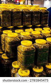 Stack of preserved grape leaves for dolma, glossy texture in a tight frame; for food design, packaging, retail promotion, recipe content. canned grape leaves, for cooking dolma, on a plate,Canned grape leaves, for cooking dolma, on a plate. Jars of various pickled vegetables. Canned grape leaves.
