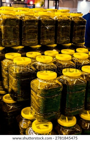 Stack of preserved grape leaves for dolma, glossy texture in a tight frame; for food design, packaging, retail promotion, recipe content. canned grape leaves, for cooking dolma, on a plate,Canned grape leaves, for cooking dolma, on a plate. Jars of various pickled vegetables. Canned grape leaves.