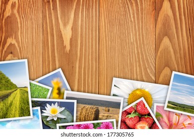 Stack of printed pictures collage on wooden table with copy space for your text or photo