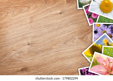 Stack of printed pictures collage on wooden table with copy space for your text or photo