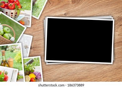 Stack of printed pictures collage on wooden table with copy space for your photo