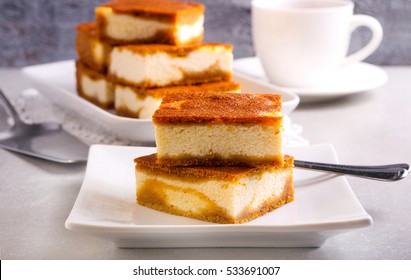 Stack Of Pumpkin Cheesecake Bars On Plate