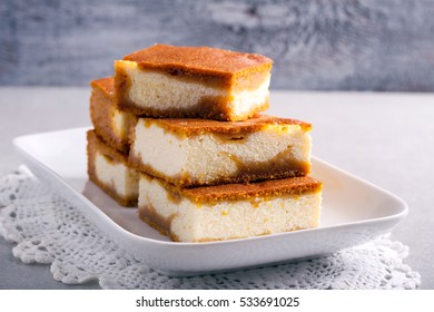 Stack Of Pumpkin Cheesecake Bars On Plate