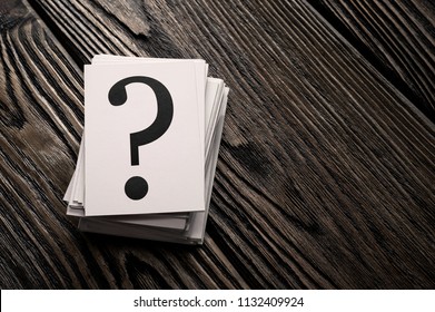 Stack of question mark cards on the wooden table with copy space - Powered by Shutterstock