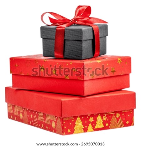 Stack of red and black gift boxes decorated with gold Christmas patterns and red ribbon, isolated on white background. Holiday composition symbolizing celebration, surprise, and festive spirit