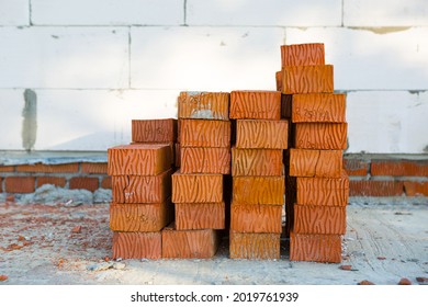 A Stack Of Red Bricks At A Construction Site. Construction Materials, Delivery, Warehouse. Copy Space