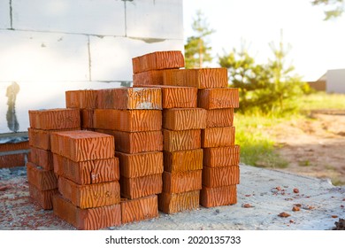 A Stack Of Red Bricks At A Construction Site. Construction Materials, Delivery, Warehouse. Copy Space