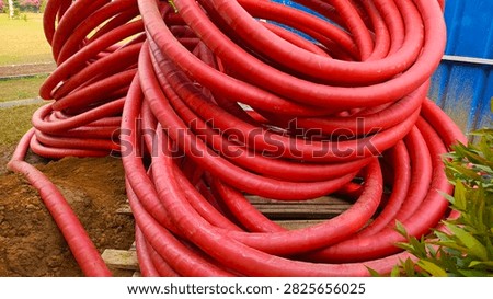 A stack of red cables, ready for installation.