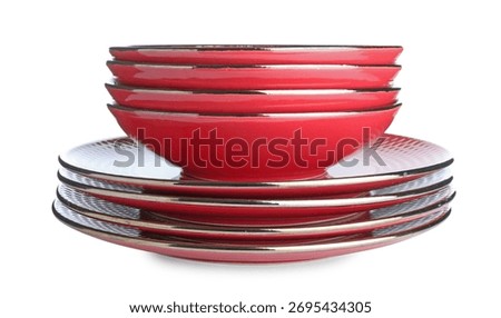 Stack of red ceramic dishware isolated on white
