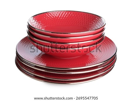 Stack of red ceramic dishware isolated on white