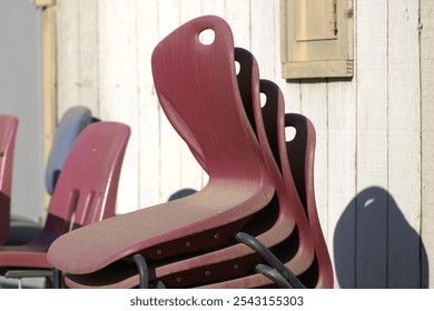 stack of red chairs outside at school