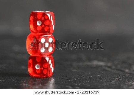 Stack of red game dices on black background