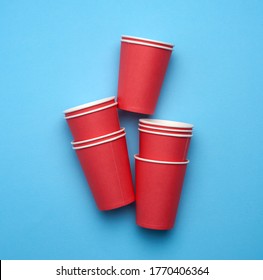 Stack Of Red Paper Disposable Cups On A Blue Background, Flat Lay, Concept Eco-friendly, Zero Waste 