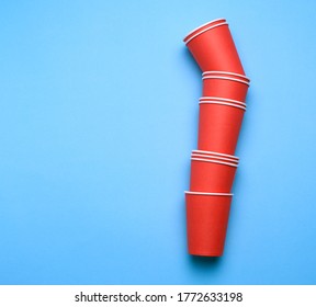 Stack Of Red Paper Disposable Cups On A Blue Background, Flat Lay, Concept Eco-friendly, Zero Waste 