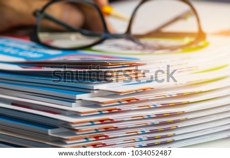 Stack of report paper documents for business desk with glasses, Business papers for Annual Reports files, Document is written,presented. Business offices concept, soft focus