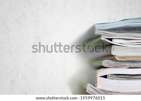 Stack of report papers lies on a desk ready for review in the office