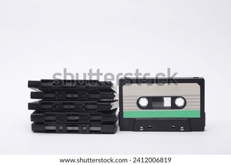 Stack of retro 80s audio cassettes on white background