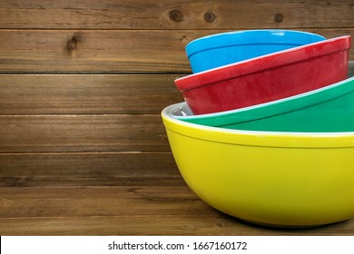 Stack Of Retro Colorful Mixing Bowls On Rustic Wood