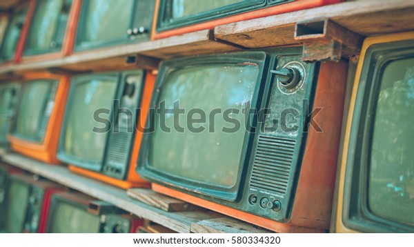 A Stack of\
retro televisions in vintage\
style.