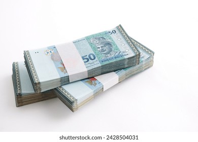 Stack of Ringgit Malaysia bank note on white background. Malaysia Currency Ringgit RM50. Selective focus.