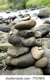 Stack of rocks next to stream