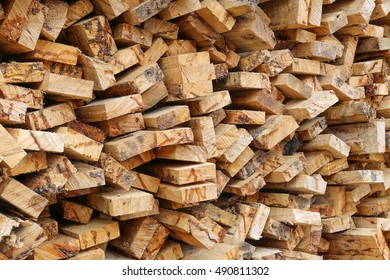 Stack Of Rough Wooden Boards With Bark, Closeup. Sawmill Waste