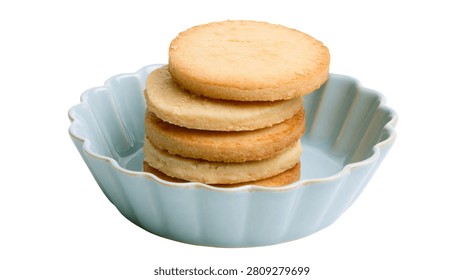 Stack of round buttery shortbread cookies in a light blue ceramic bowl