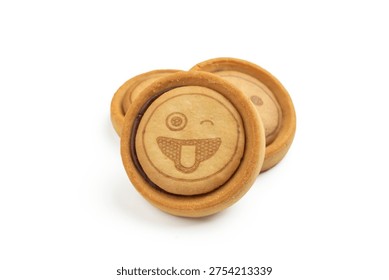 Stack of round cookies with funny winking face emoticon and chocolate cream filling, isolated on white background.
