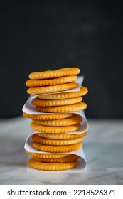 Stack of round salted crackercookies on table with lighting - Shutterstock ID 2218526371