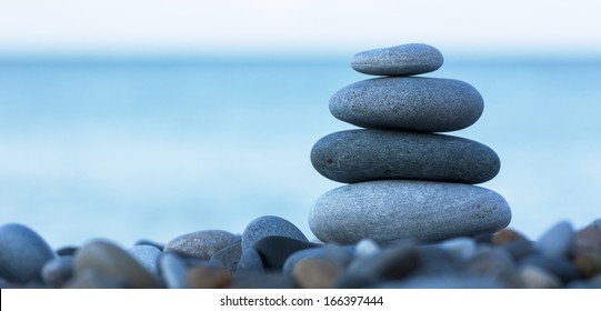 Stack of round smooth stones on a seashore