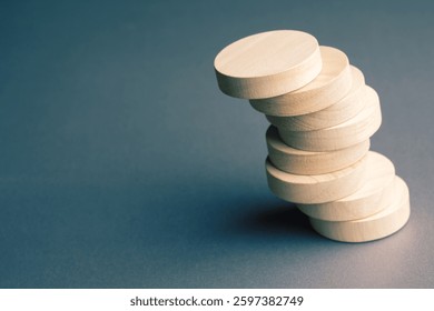 Stack round wooden pieces in a structure that is at risk of collapsing, potential loss situation, risk management concept