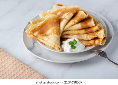 Stack Of Russian Thin Pancakes Blini With Fresh Sour Cream.