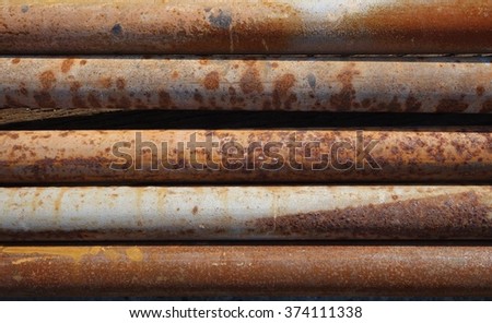 A stack of rusty metal pipes