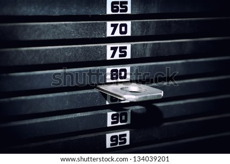 Stack of rusty metal weights in gym bodybuilding equipment