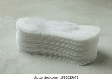 Stack Of Sanitary Pads On White Textured Background