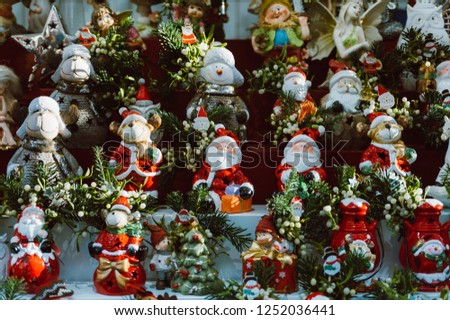 stack of santa claus puppets and statuettes as christmas decorations in winter traditional hadmade market