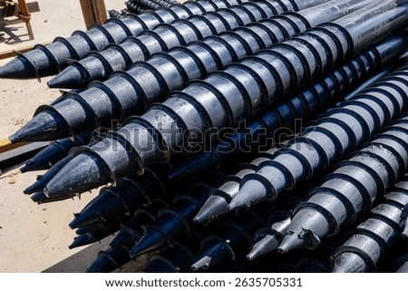 Stack of screw piles for house foundation.