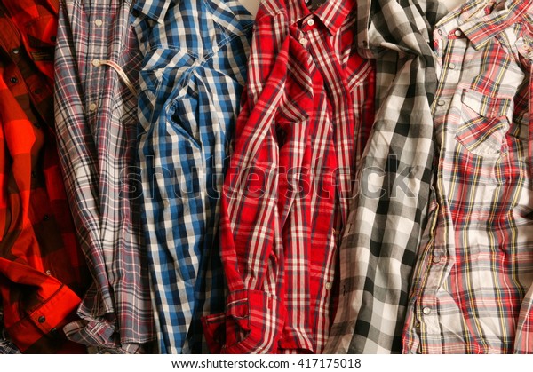 stack of shirts, stack\
of checked shirts