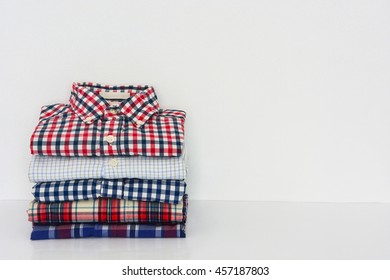 Stack Of Shirts Isolated On White, Copy Space