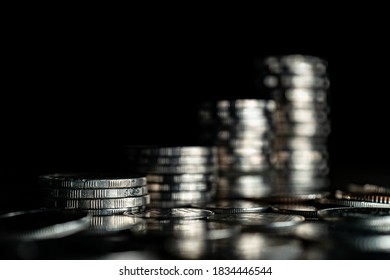 Stack Of Silver Coins On Dark Background.