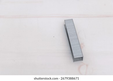 Stack of silver metal stapler staples isolated on white background, office supplies and stationery closeup concept