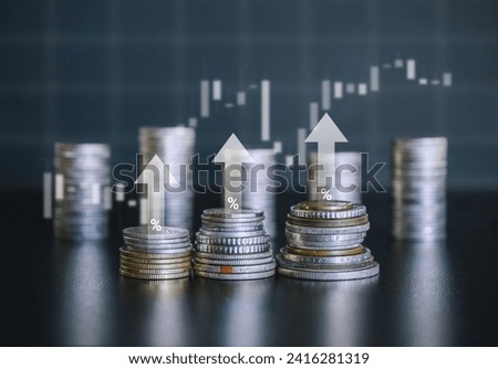 Stack of silver money coin with white up arrow, trading candle bar and percent symbol. Business and financial background concept.