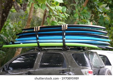 Stack Of Six Surfboards On A Car Roof Rack